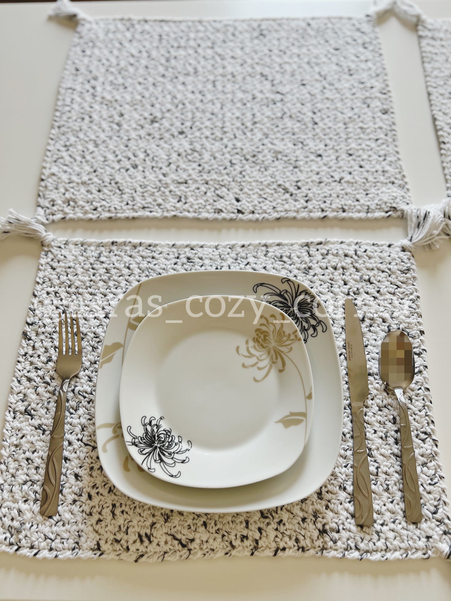 Black and white crochet placemat with tassels