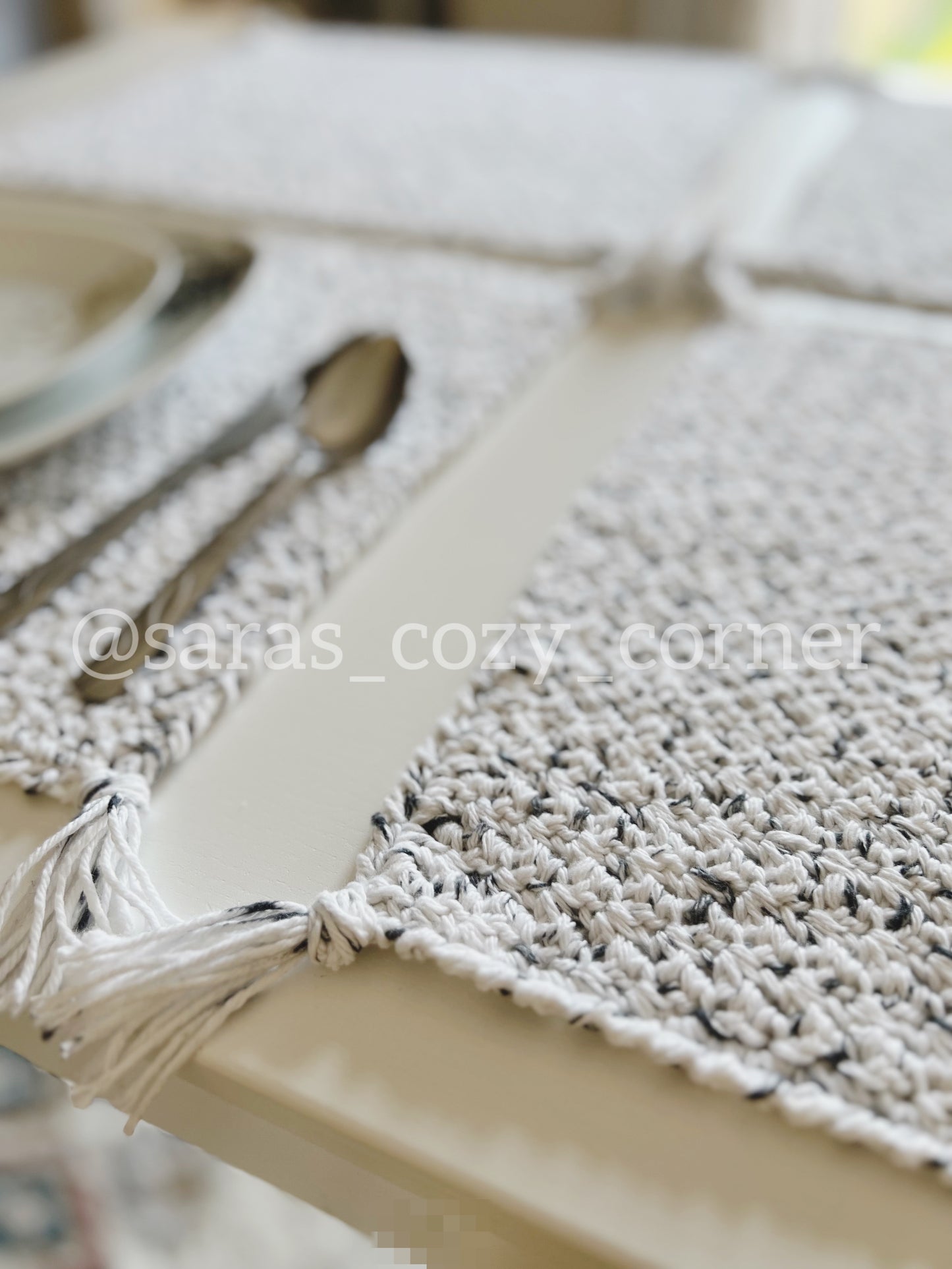 Black and white crochet placemat with tassels