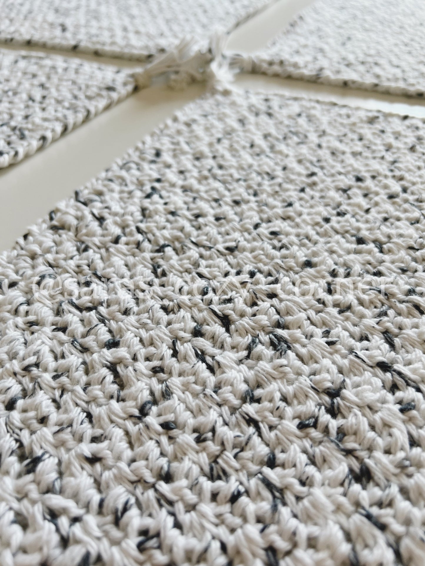 Black and white crochet placemat with tassels