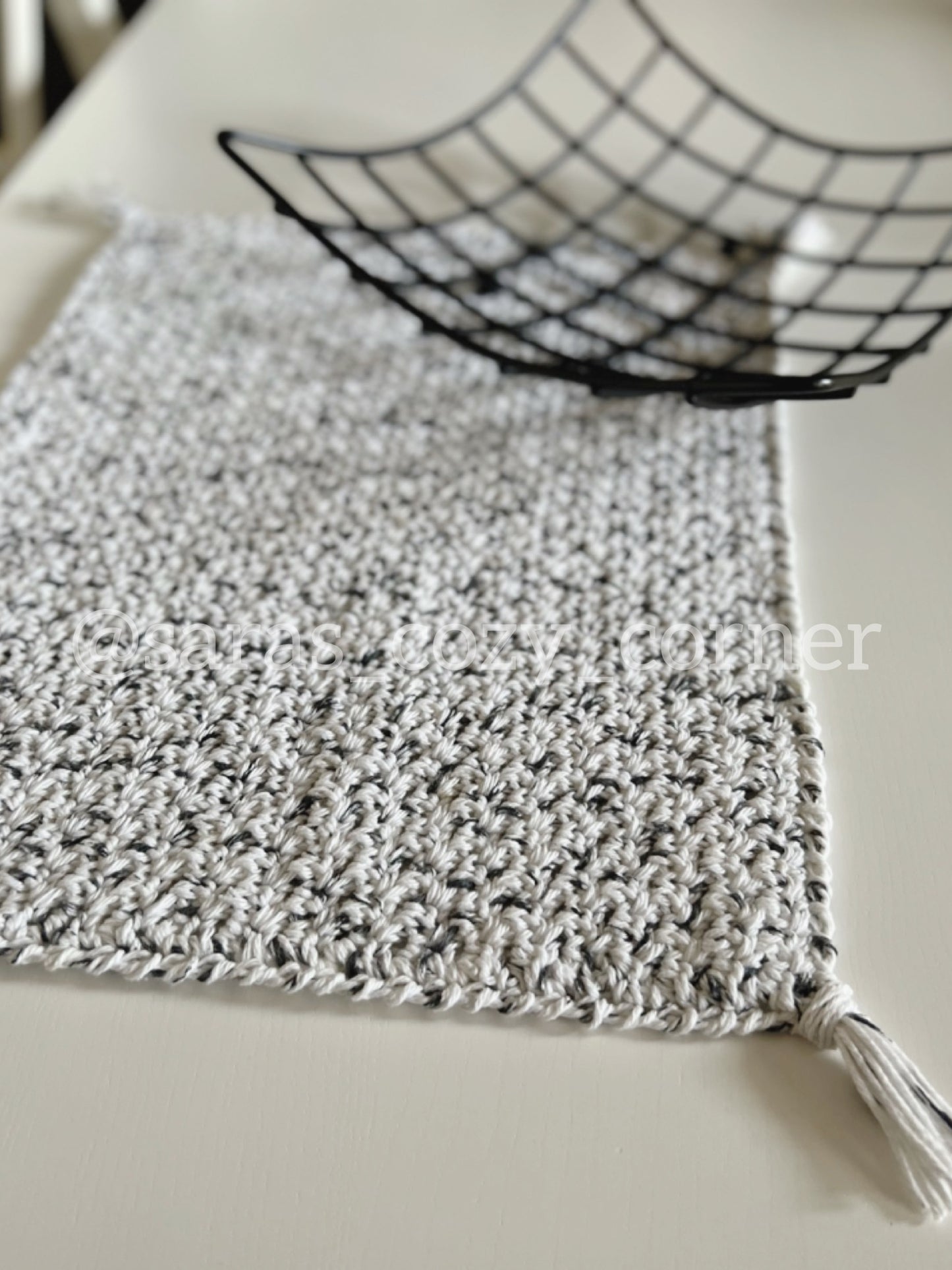 Black and white crochet placemat with tassels